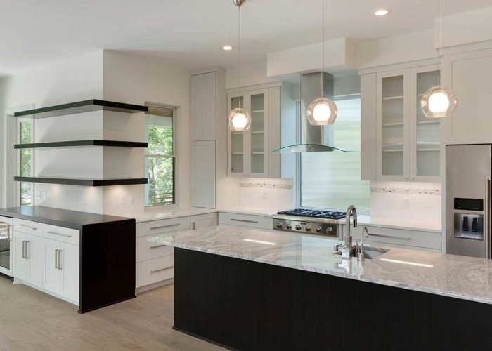 Black center island with white marble countertop