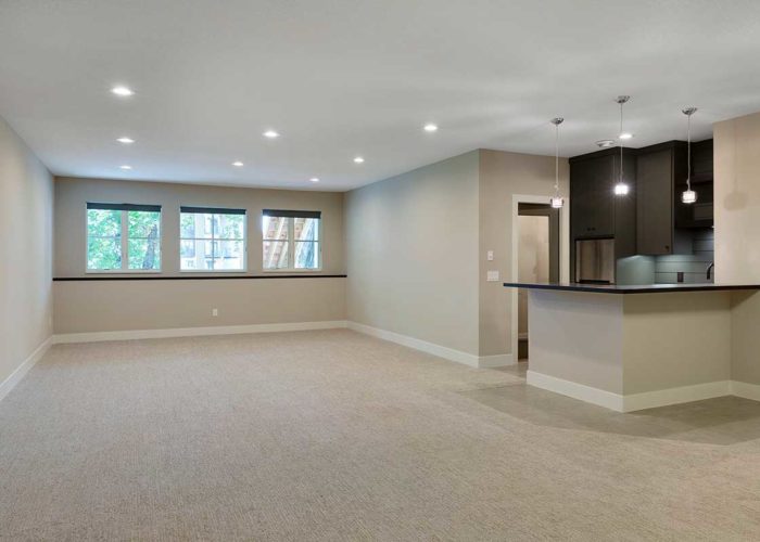 Unfurnished living space with view of kitchen
