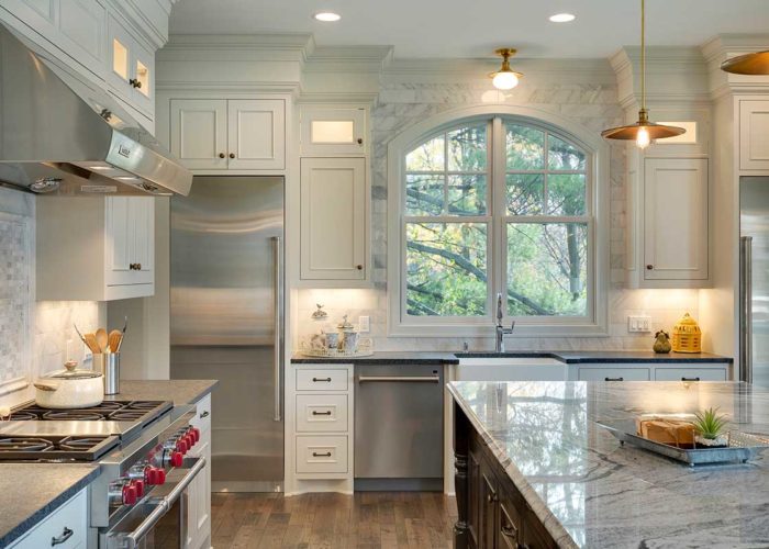 Kitchen with white cabinets and marble countertops