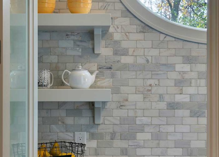Detail of marble backsplash and shelving in bathroom
