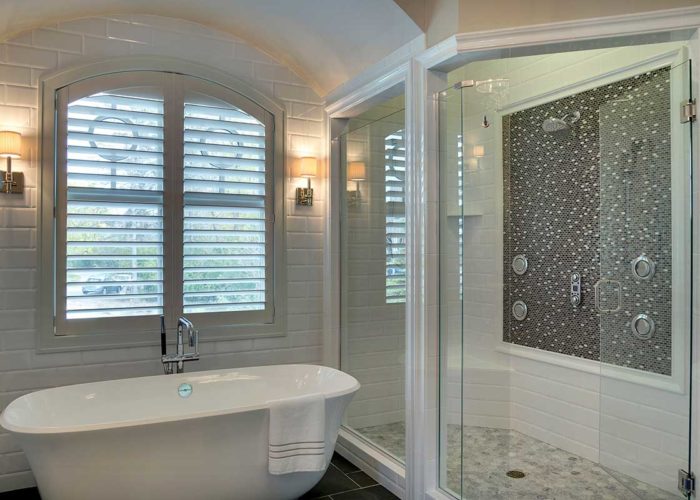 Luxury bathroom with separate tub and glass shower