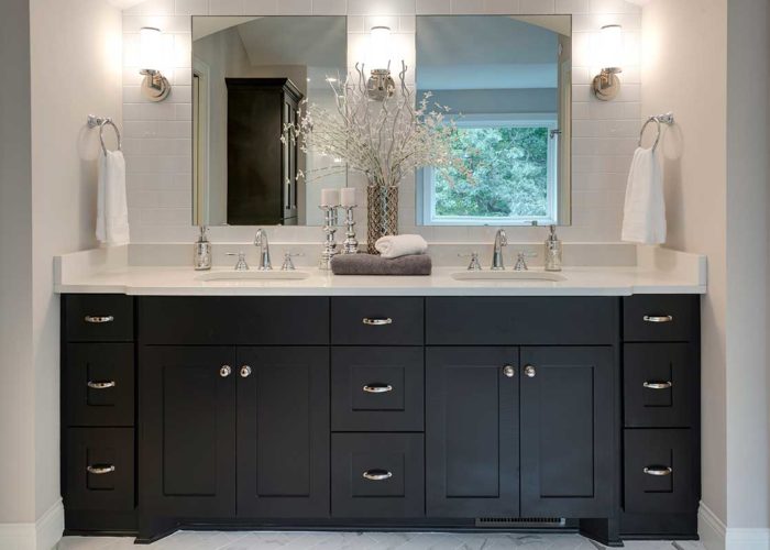 Double bathroom vanity with black cabinets and stainless hardware
