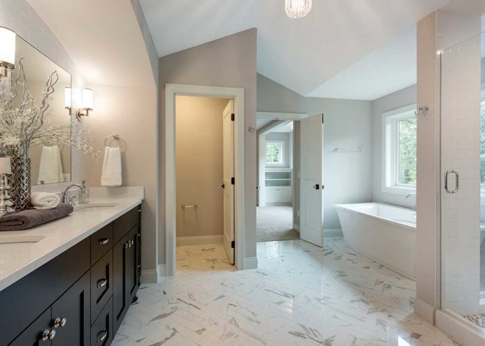Large luxury bathroom with marble tile flooring and double vanity