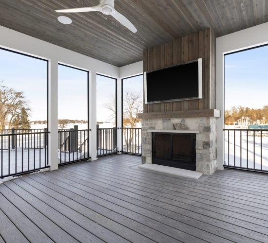 Screen porch with stone fireplace and wood ceiling