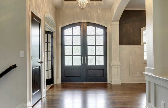 Front entryway of home with two small chandeliers