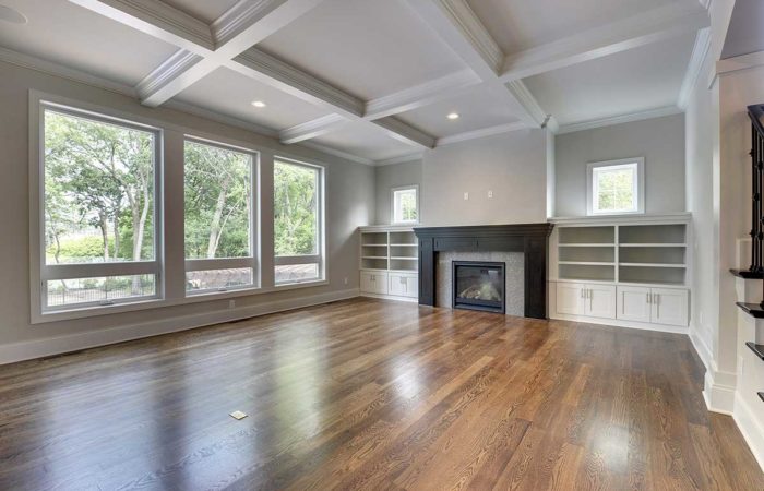 Large living space with wood flooring and fireplace