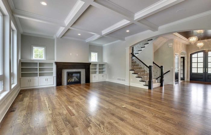 Large living space with wood flooring and fireplace