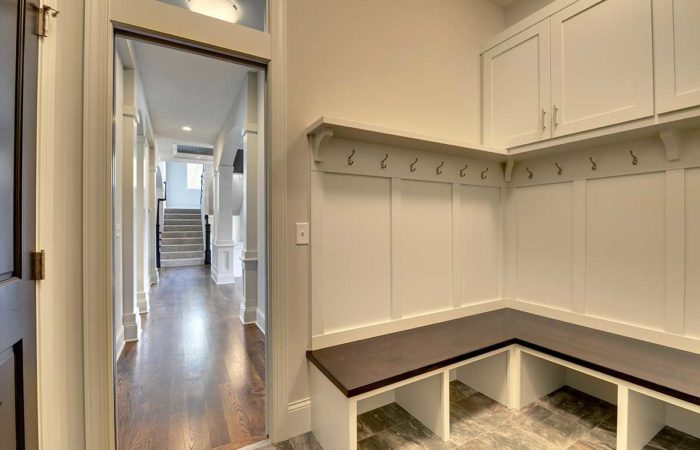 Mudroom with white cabinets