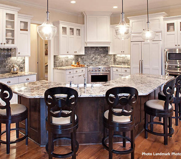 Large island with dark cabinets and chairs