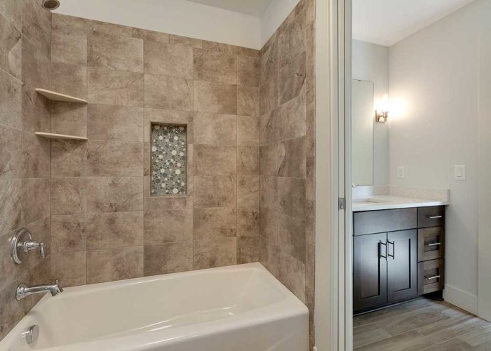 Large bath tub with rustic tile