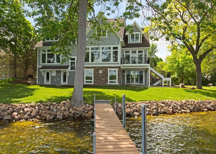 Exterior of back of home with dock on lake