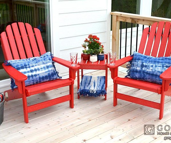 Red chairs with blue accent pillows on deck
