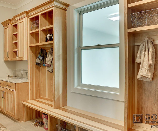 Exposed pine grain cabinets in mudroom
