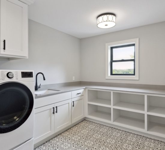 laundry room with storage and patterned tiled floor
