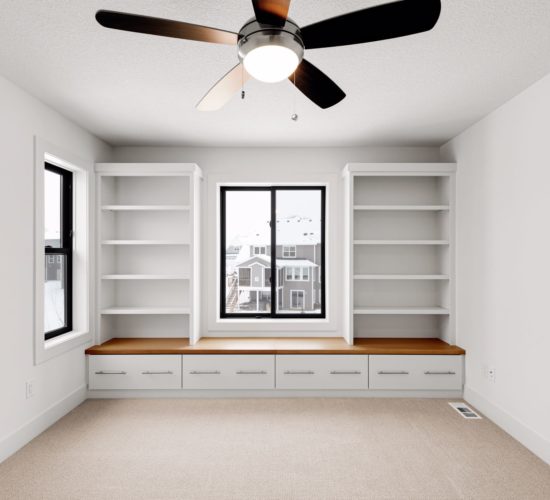 bedroom with built-ins and windows bench
