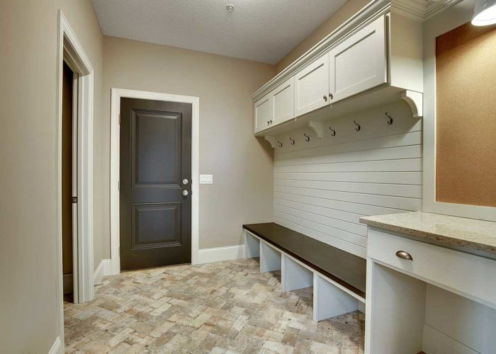 Mud room with distressed tile