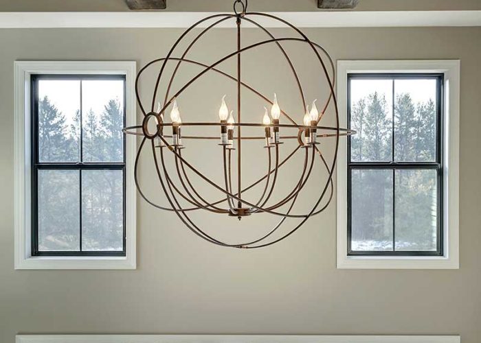 Close up chandelier accent with exposed beam ceiling