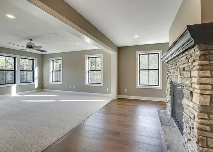 Unfurnished living space with stacked stone fire place