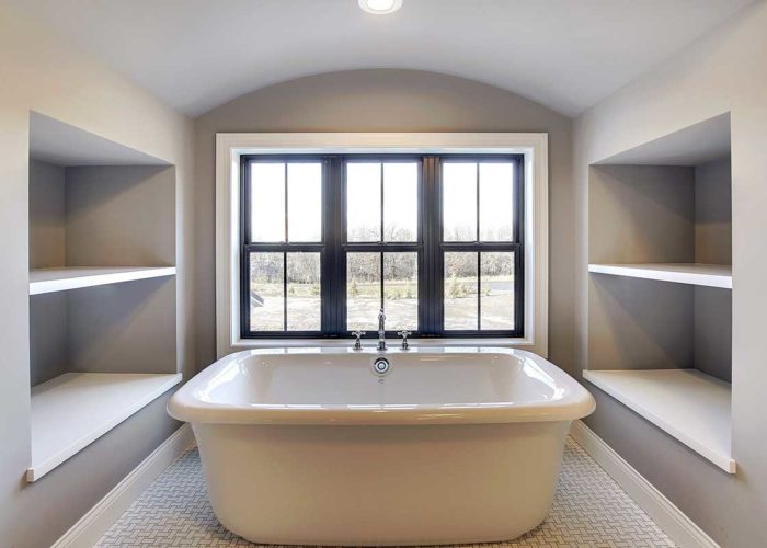 Large tub with bathroom storage and window