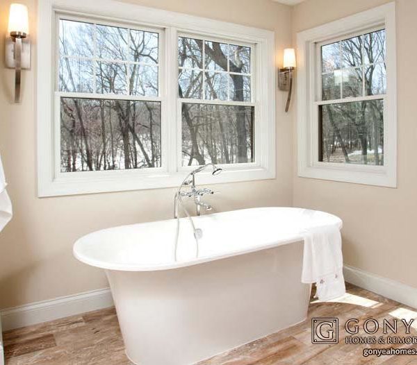 Large tub in a bathroom with wooden tile